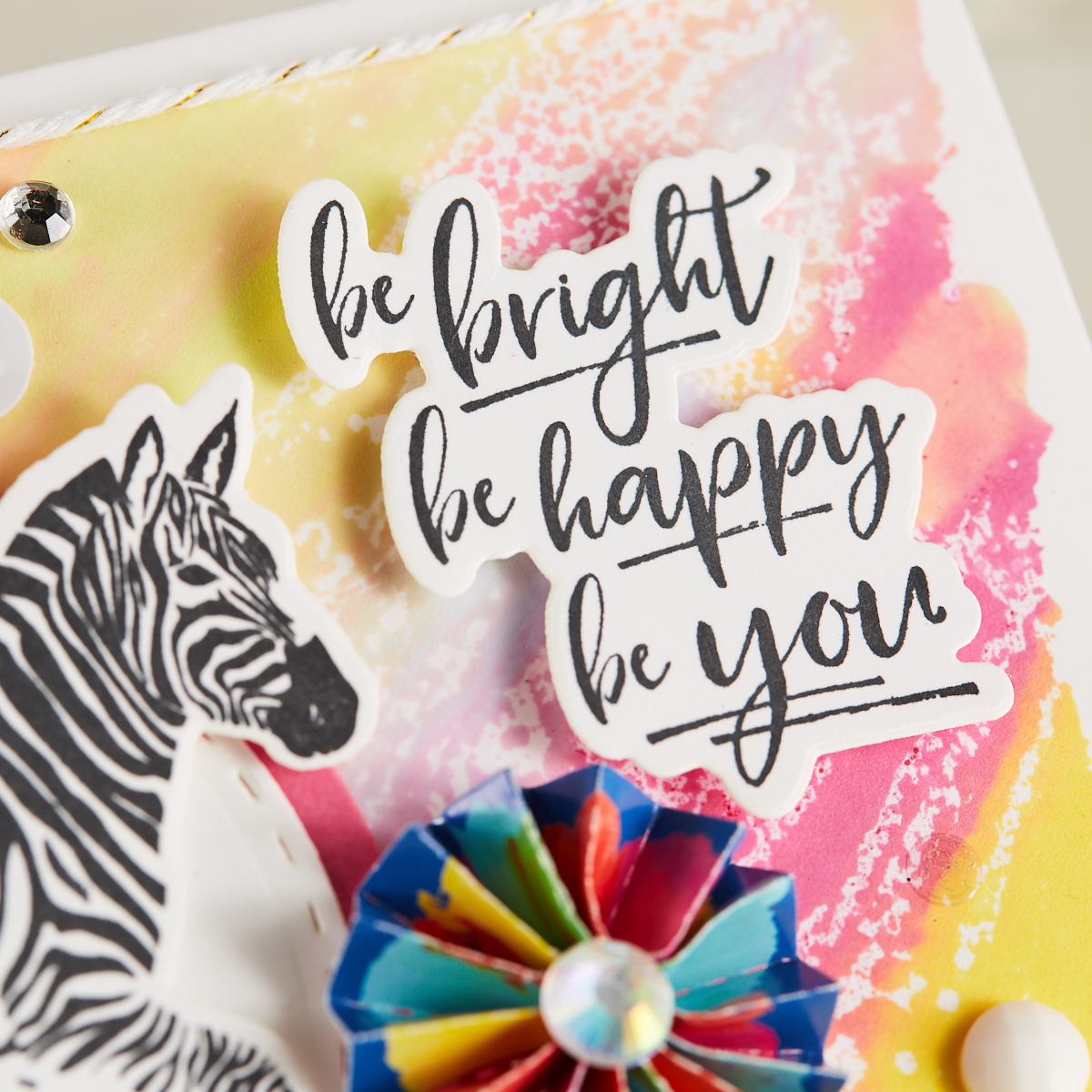 closeup of zebra card that says Be Bright, Be Happy, Be You, by Mariana Grigsby with watercolor background and rubber stamped zebra