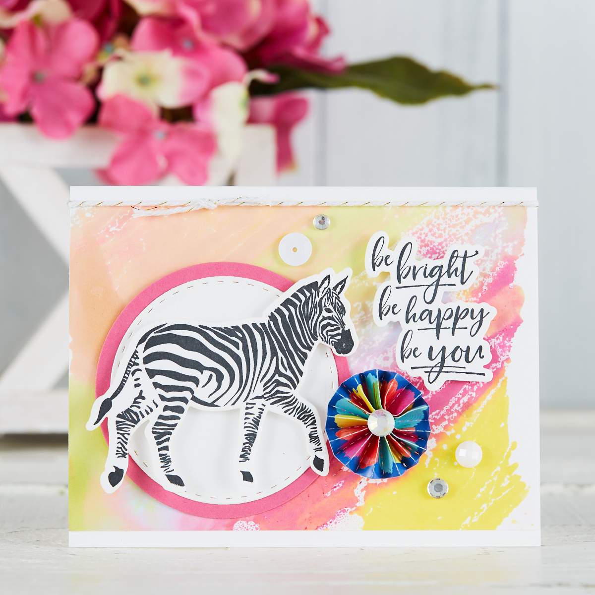 handmade card by Mariana Grigsby with zebra stamp from Escape the Ordinary Stamp Set from Fun Stampers Journey, with Gel Press watercolor background in pink, peach and yellow #funstampersjourney #cardmaking