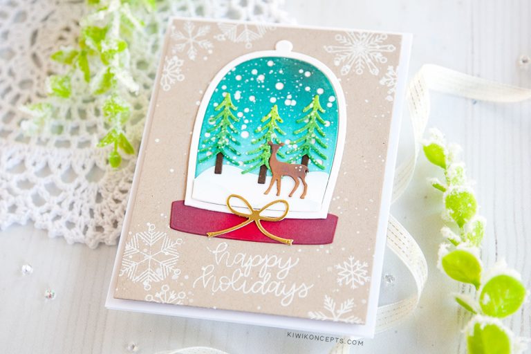 Spellbinders Die D-Lites Holiday 2019 Inspiration | Clean & Simple Christmas Cards with Keeway Tsao. Keeway says: "This card showcases the Shapeabilities Santa’s Workshop dies. This die creates a beautiful little scene within a snow globe. I started by die cutting the snow globe frame and backing which was then ink blended with Peacock Feathers and Tumbled Glass distress oxide inks."